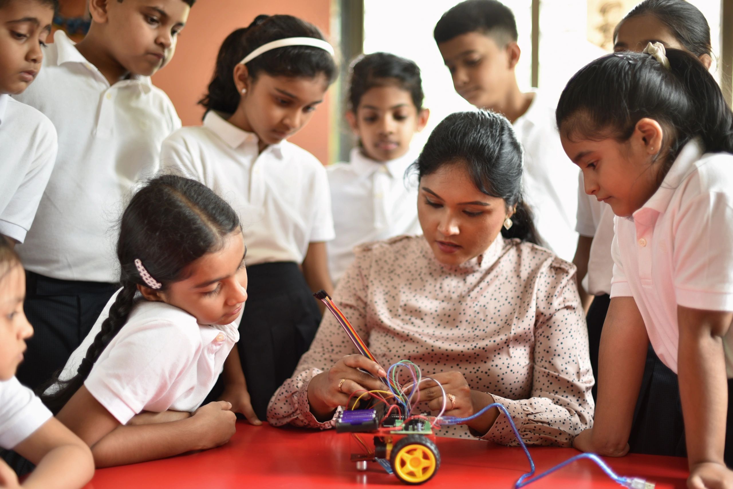 Students learning robotics with their teacher