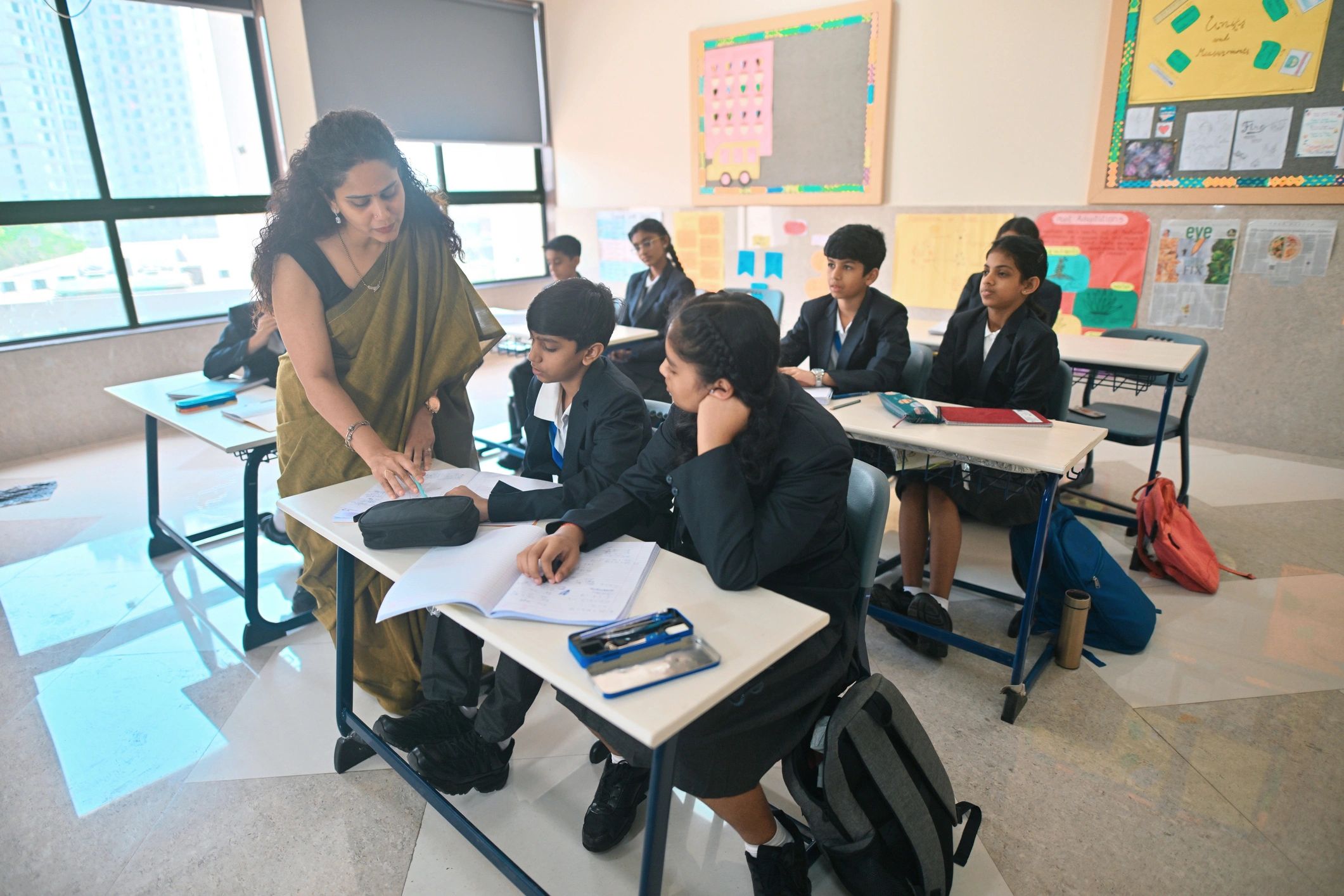 Teacher providing hands-on guidance to students